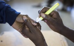 A voter gets a finger inked at a polling station on May 8, 2019 during the legislative and presidential elections in South Africa.