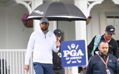Scottie Scheffler (L) and caddie Ted Scott walk to the driving range on Friday after his arrest and release before round two of the PGA Championship