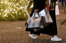 A woman carries shopping bags. 